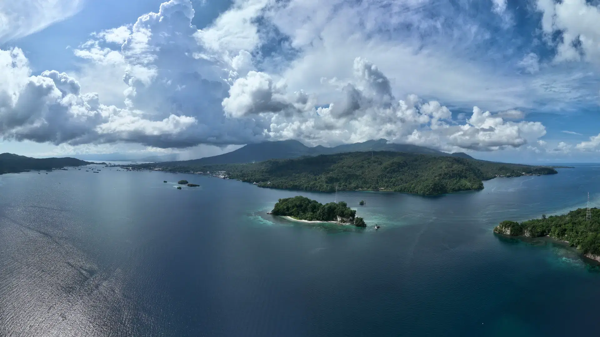 Clouds drift above Lembeh Strait, separating North Sulawesi from Lembeh Island. This tropical area is home to a plethora of marine biodiversity and is popular among divers.