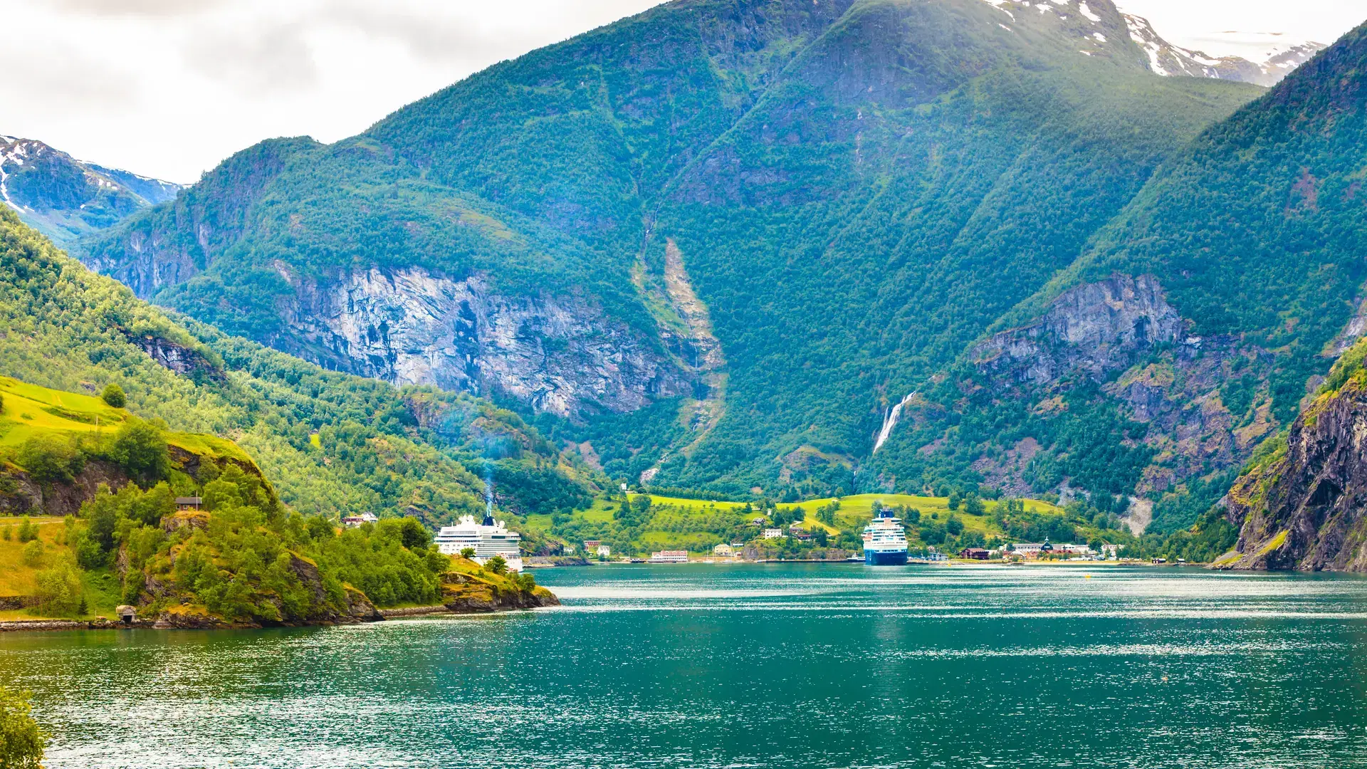 Tourism vacation and travel. Mountains landscape and big cruise ship on fjord Sognefjord in Flam Norway Scandinavia.