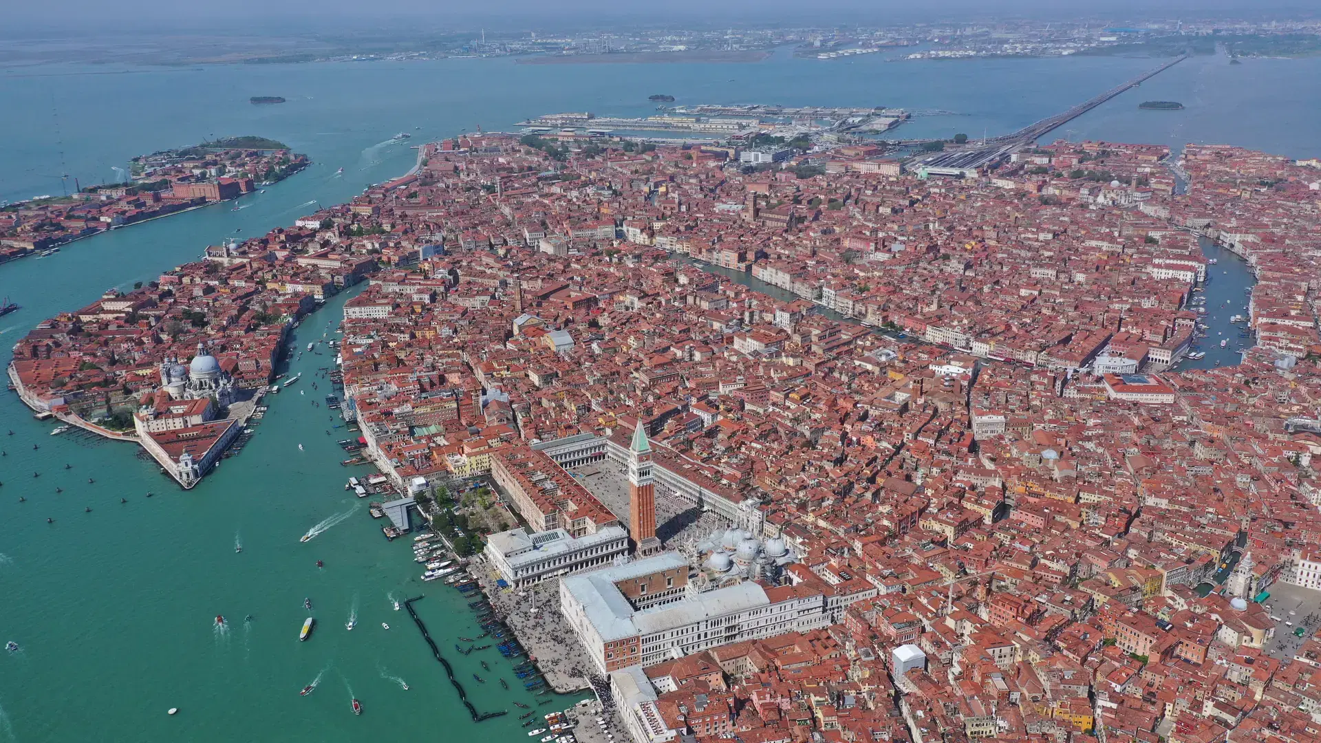 Aerial drone panoramic photo of iconic and unique Sant Marks square and Santa Maria della Salute Cathedral in Grand Canal crossing city of Venice, Italy