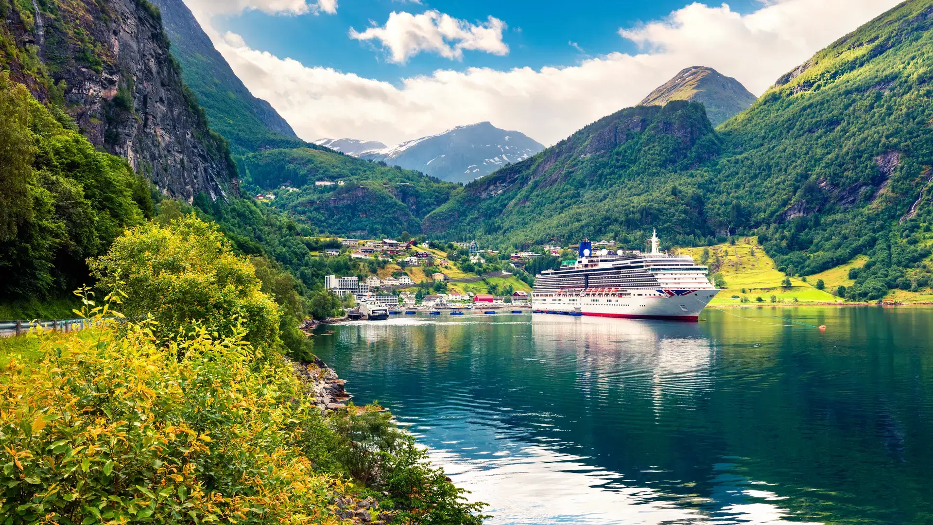Sunny summer scene of Geiranger port, western Norway. Colorful view of Sunnylvsfjorden fjord. Traveling concept background. Artistic style post processed photo.