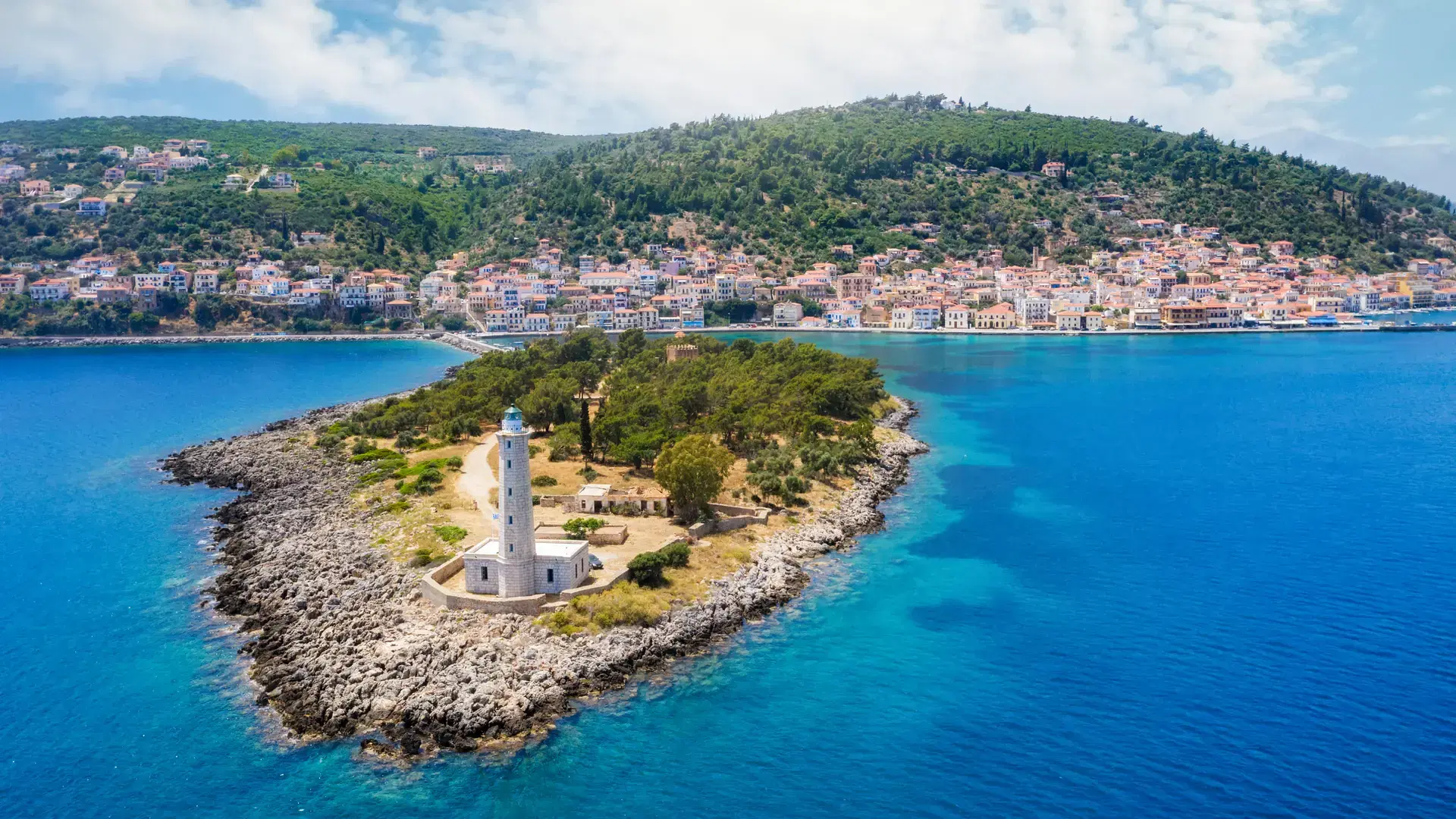 Aerial view to the lighthouse and picturesque town of Gythio, south Peloponnese, Greece, with turquoise sea and sunshine