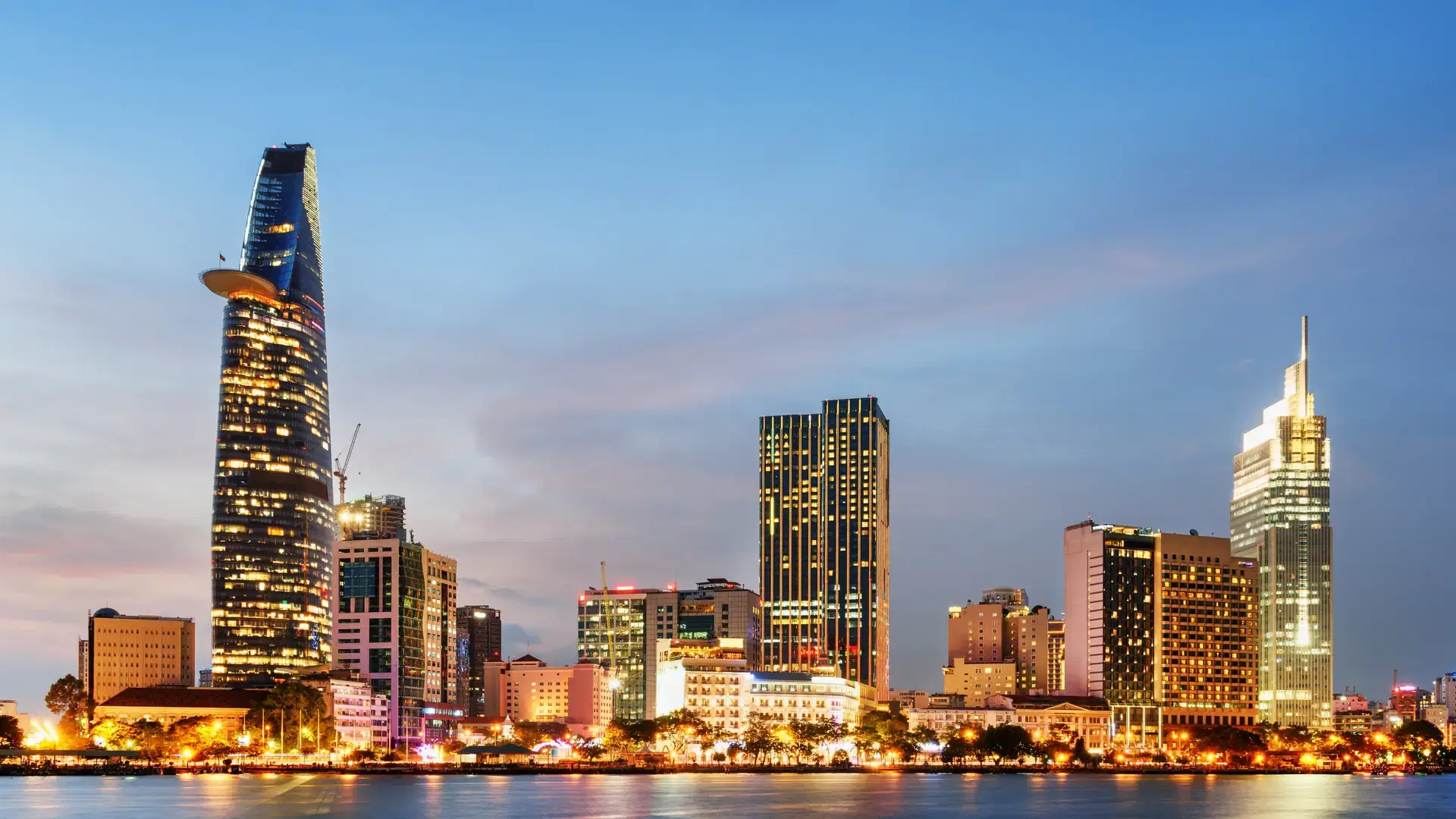 Ho Chi Minh City skyline and the Saigon River at sunset. Wonderful view of skyscraper and other modern buildings at downtown. Ho Chi Minh City is a popular tourist destination of Vietnam.