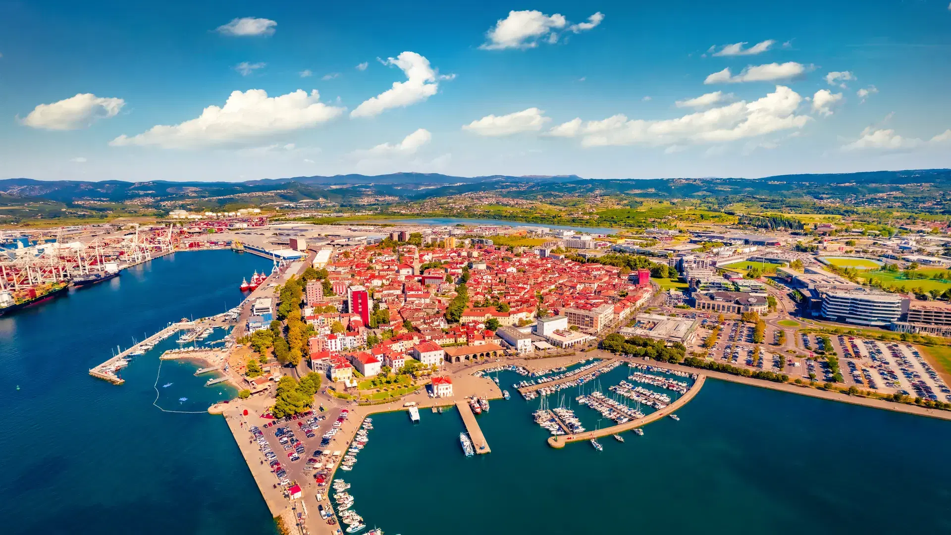 Incredible summer view from flying drone of Koper port. Aerial outdoor scene of Adriatic coastline, Slovenia, Europe. Stunning Mediterranean seascape. Traveling concept background.