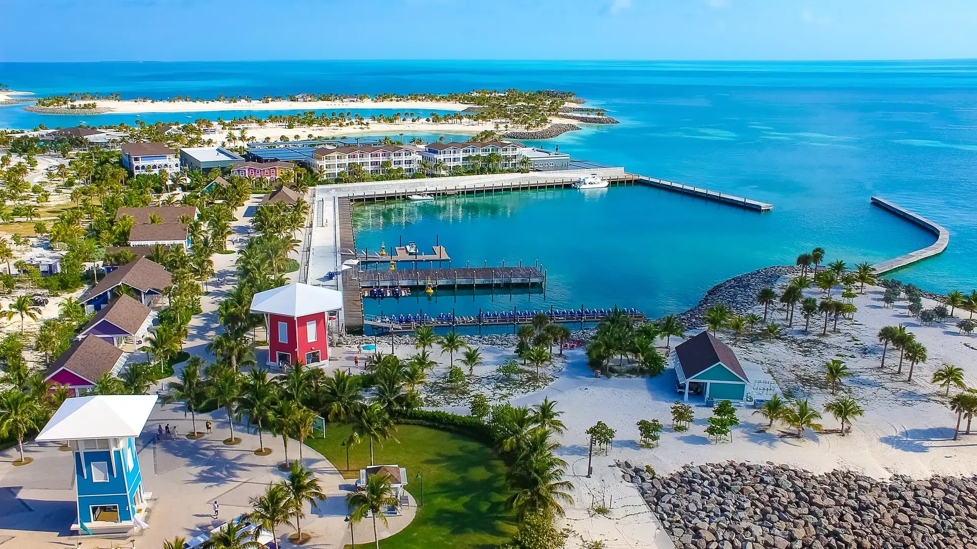 Beach on Ocean Cay Bahamas Island with colorful houses and turquoise water