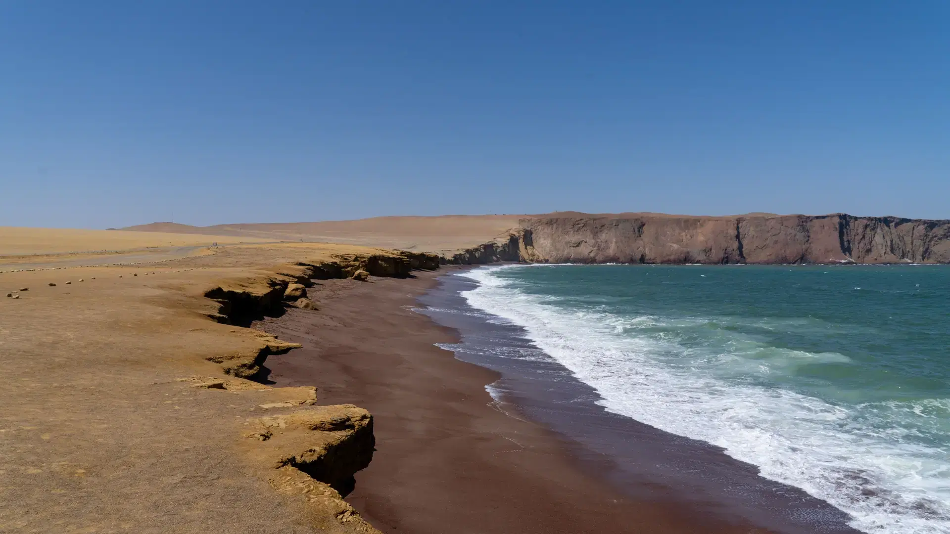 A beautiful shot of a red sand beach in the Paracas National Park, Peru