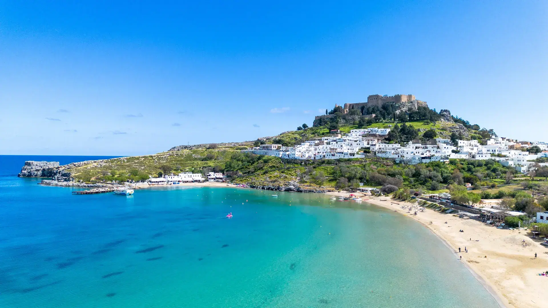 Rhodes, Greece. Lindos small whitewashed village and the Acropolis, scenery of Rhodos Island at Aegean Sea.