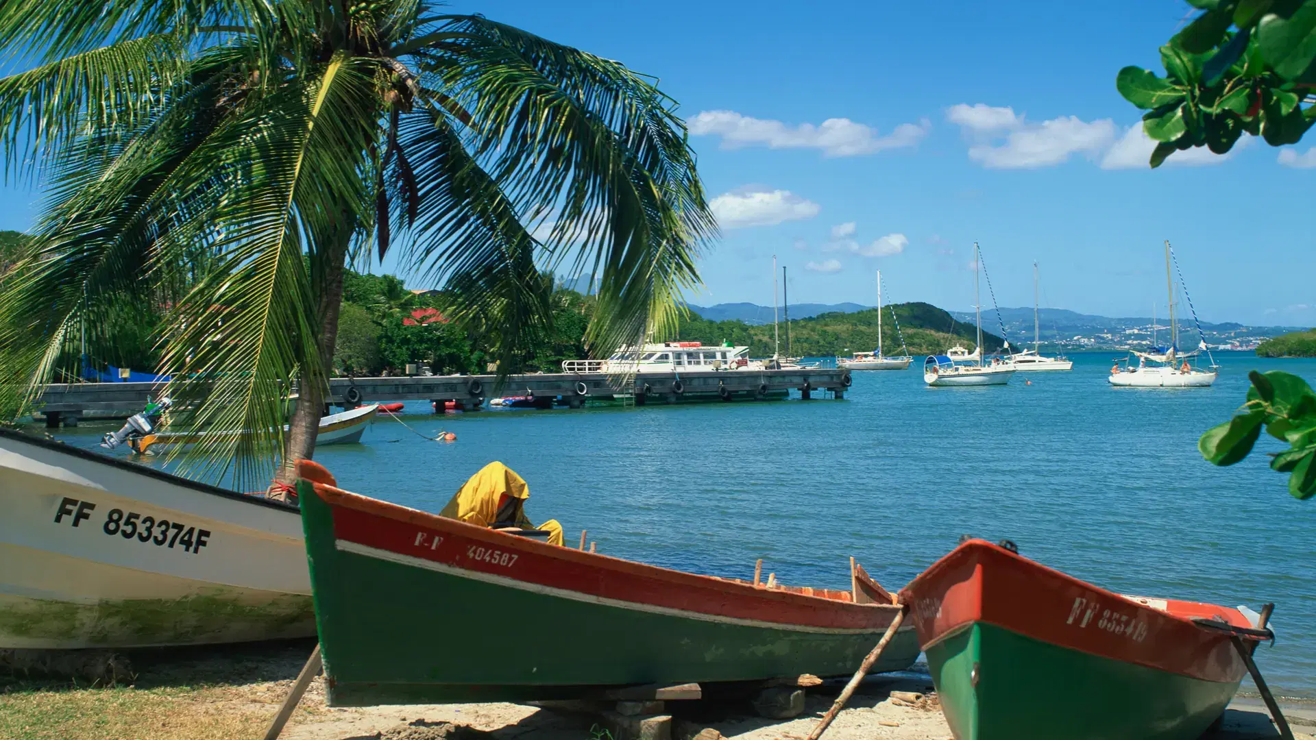 Fishing boats pulled up onto the beach at trois ilets harbour, martinique, lesser antilles, west indies, caribbean, central america
