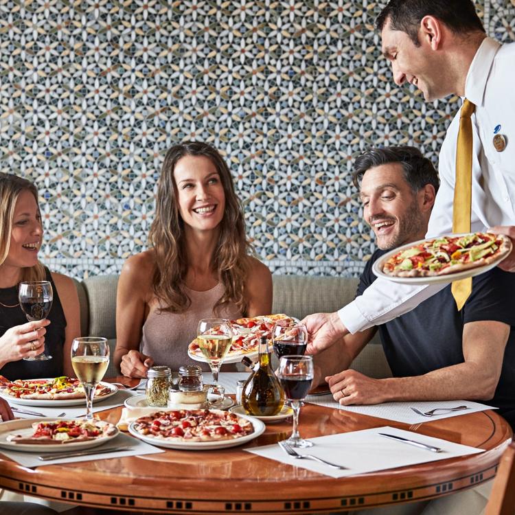 Waiter Serving Pizza
