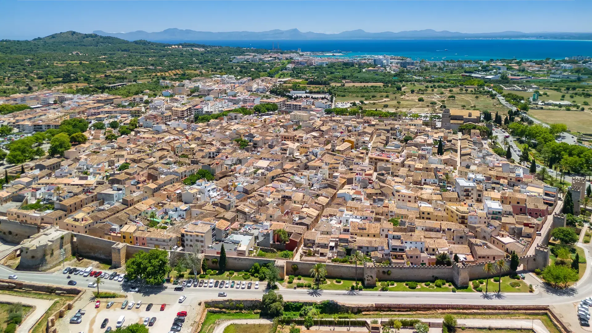 Aerial view of the picturesque town of Alcudia in Mallorca at sunny day, Balearic Islands, Spain. Charming medieval walled town on Majorca island
