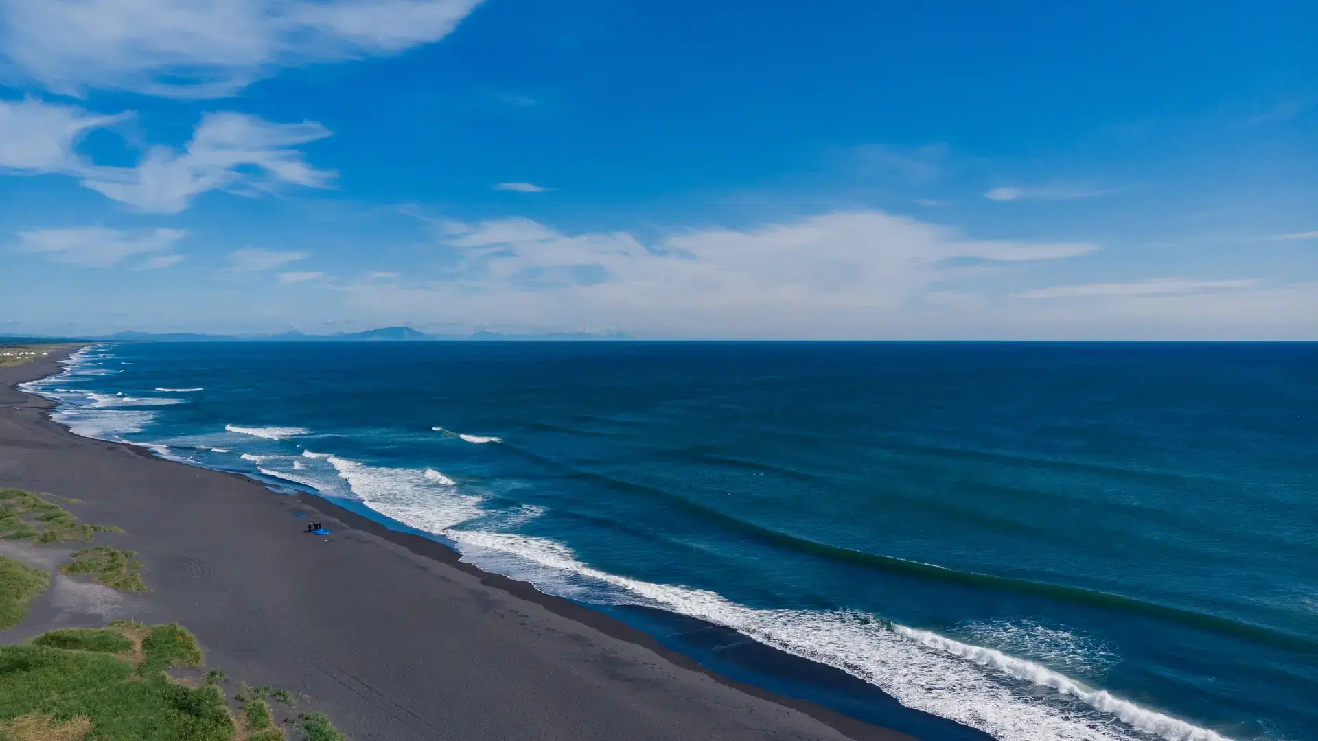 Beautiful nature Landscape of Khalaktyrsky beach with black volcanic sand coast of North Pacific Ocean Kamchatka Russia, aerial top view.