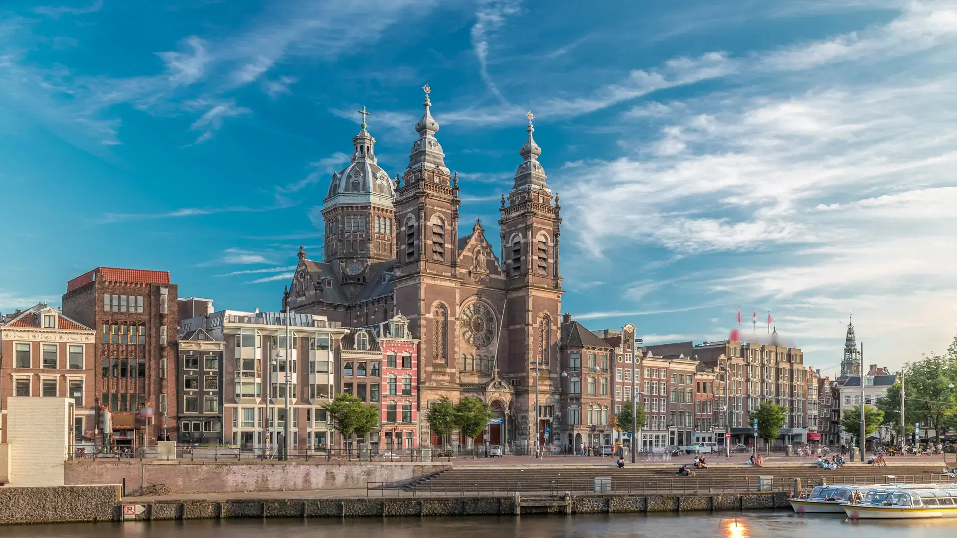 Hyperlapse of the Basilica of Saint Nicholas in Amsterdams Old Centre near the Central Station. People walking along the waterfront by the boat station timelapse. Amsterdam, Netherlands