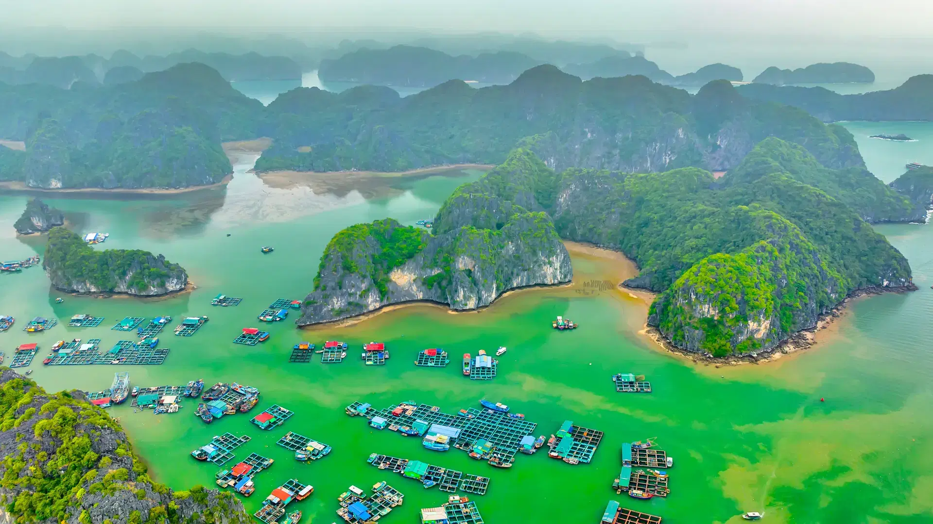 Floating fishing village and rock island in Lan Ha bay, Vietnam, Southeast Asia. UNESCO World Heritage Site. Popular landmark, famous destination of Vietnam. Near Halong bay