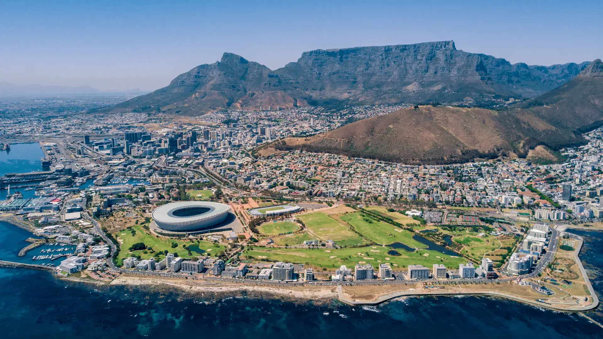 Aerial view of Cape Town highlighting Table Mountain and the cityscape during sunny weather