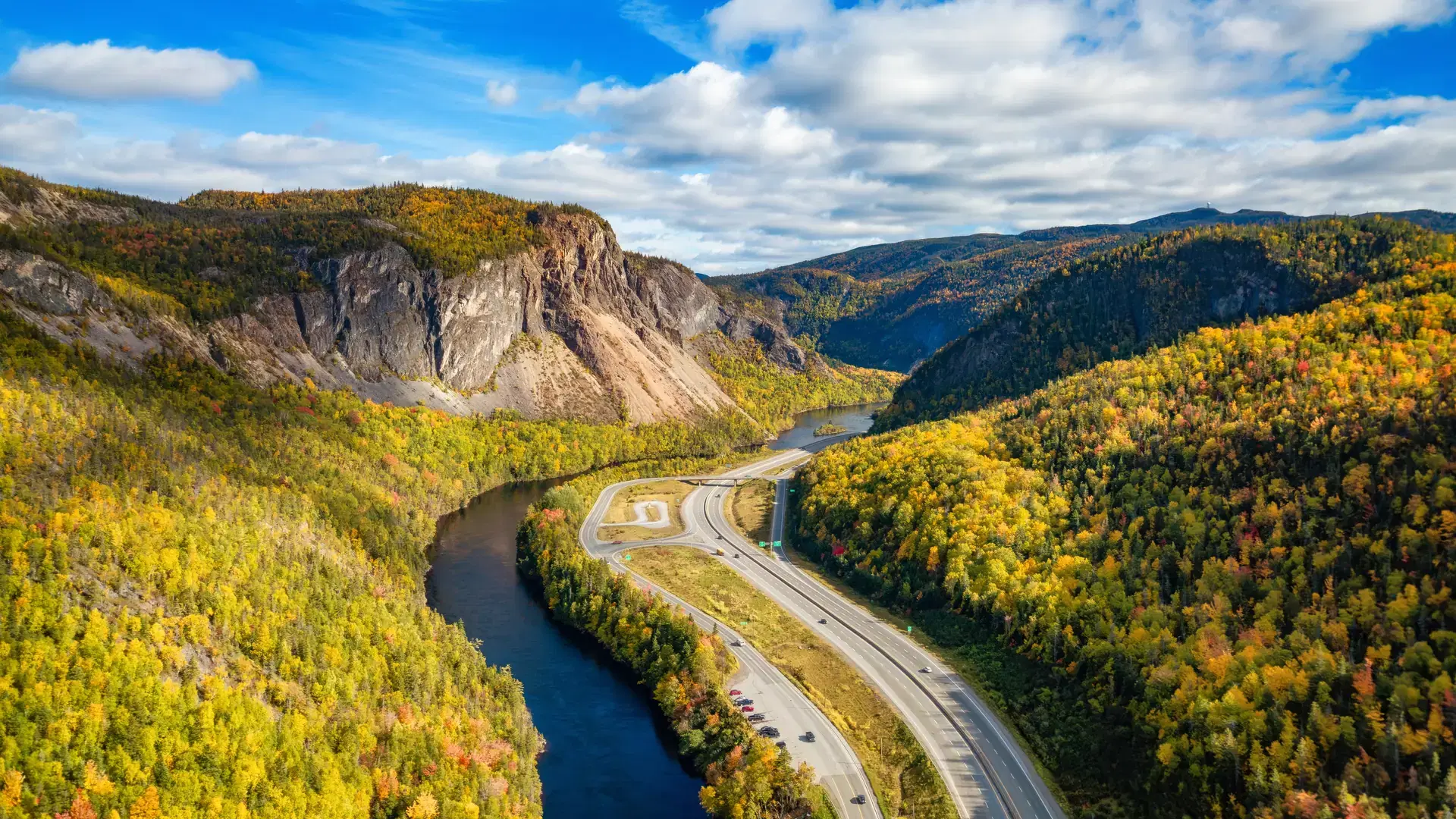 Scenic road in Canadian Mountain Landscape Valley with River. Fall Season. Corner Brook, Newfoundland, Canada.