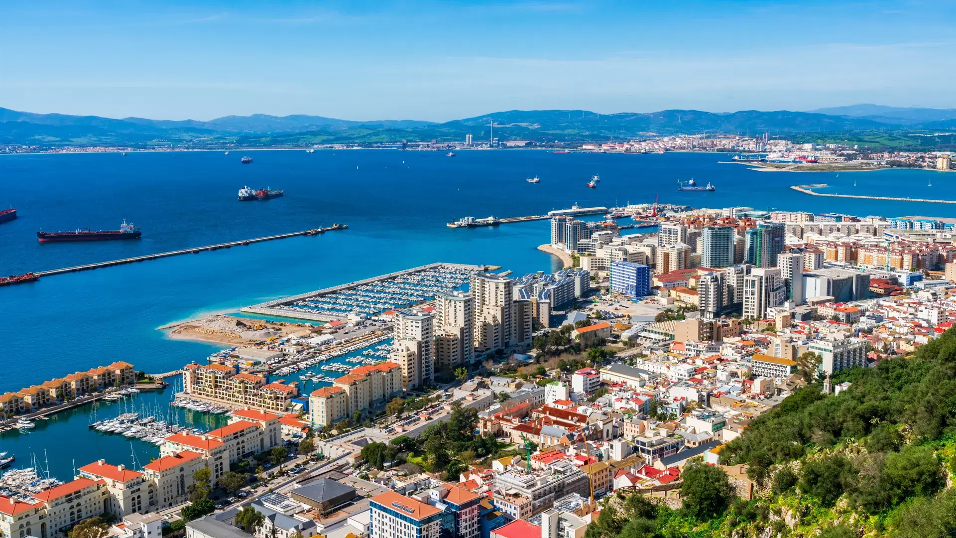 View of Gibraltar town - a British Overseas Territory, and Spain across Bay of Gibraltar from the Upper Rock. UK