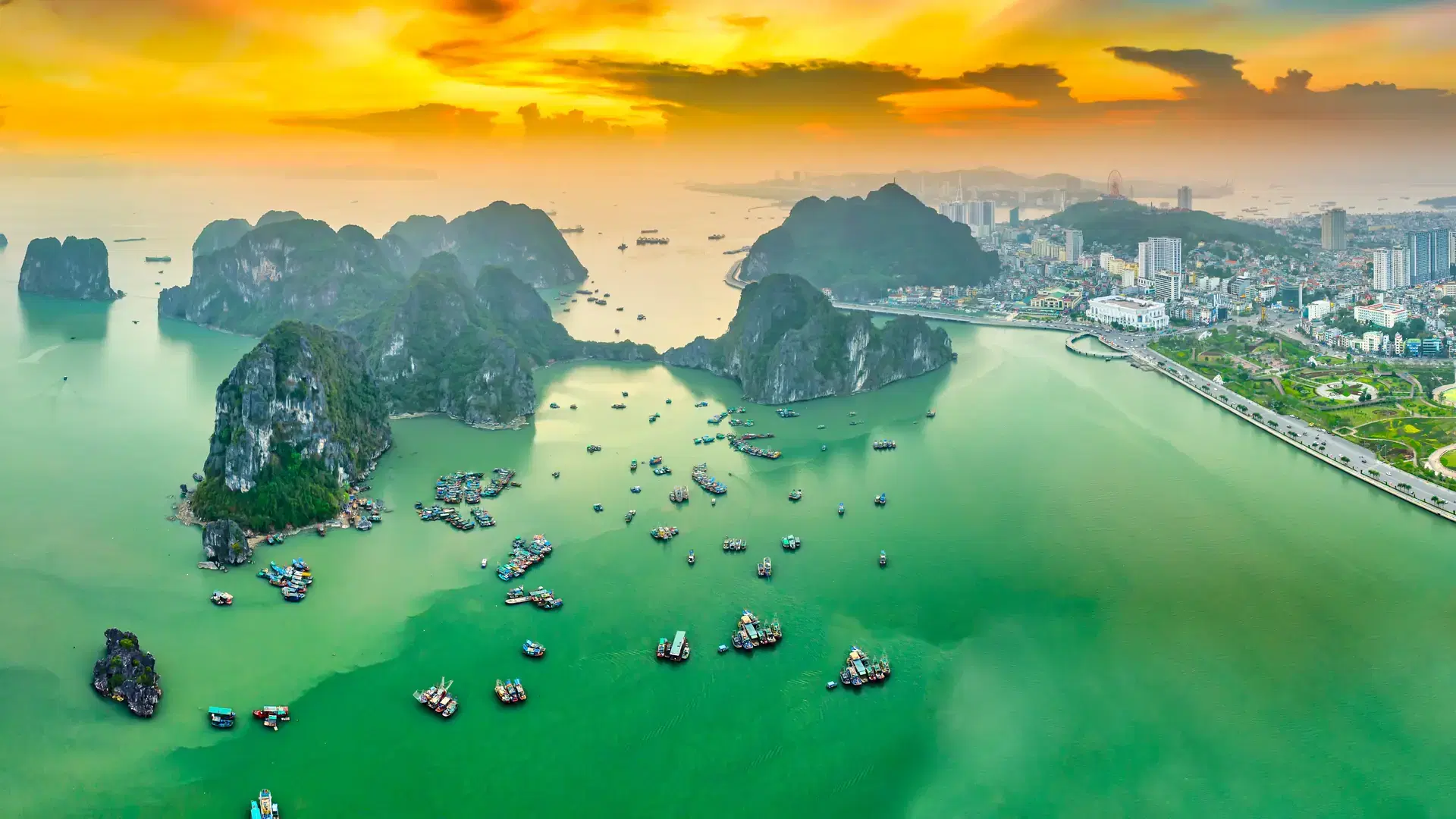 Aerial view of Ha Long cityscape at sunset in Northern Vietnam. Urban development texture, transport infrastructure. Near Halong Bay. Popular landmark, famous destination of Vietnam.
