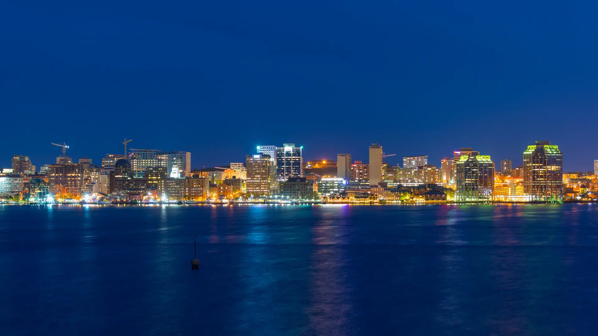 Halifax City skyline at night from Dartmouth waterfront, Nova Scotia, Canada.