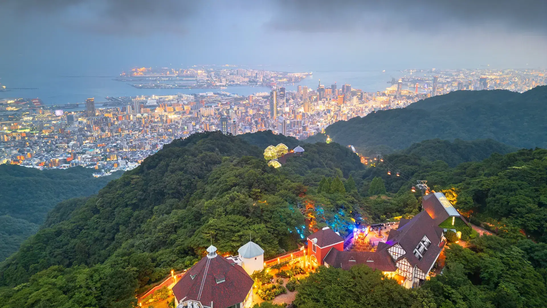 Kobe, Japan city skyline from the mountains at dusk.