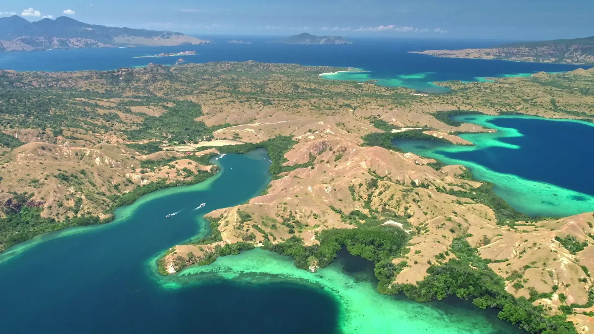 Capturing the stunning aerial view of Komodo national park, Indonesia, reveals turquoise waters embracing lush islands in a vibrant tapestry of natures beauty
