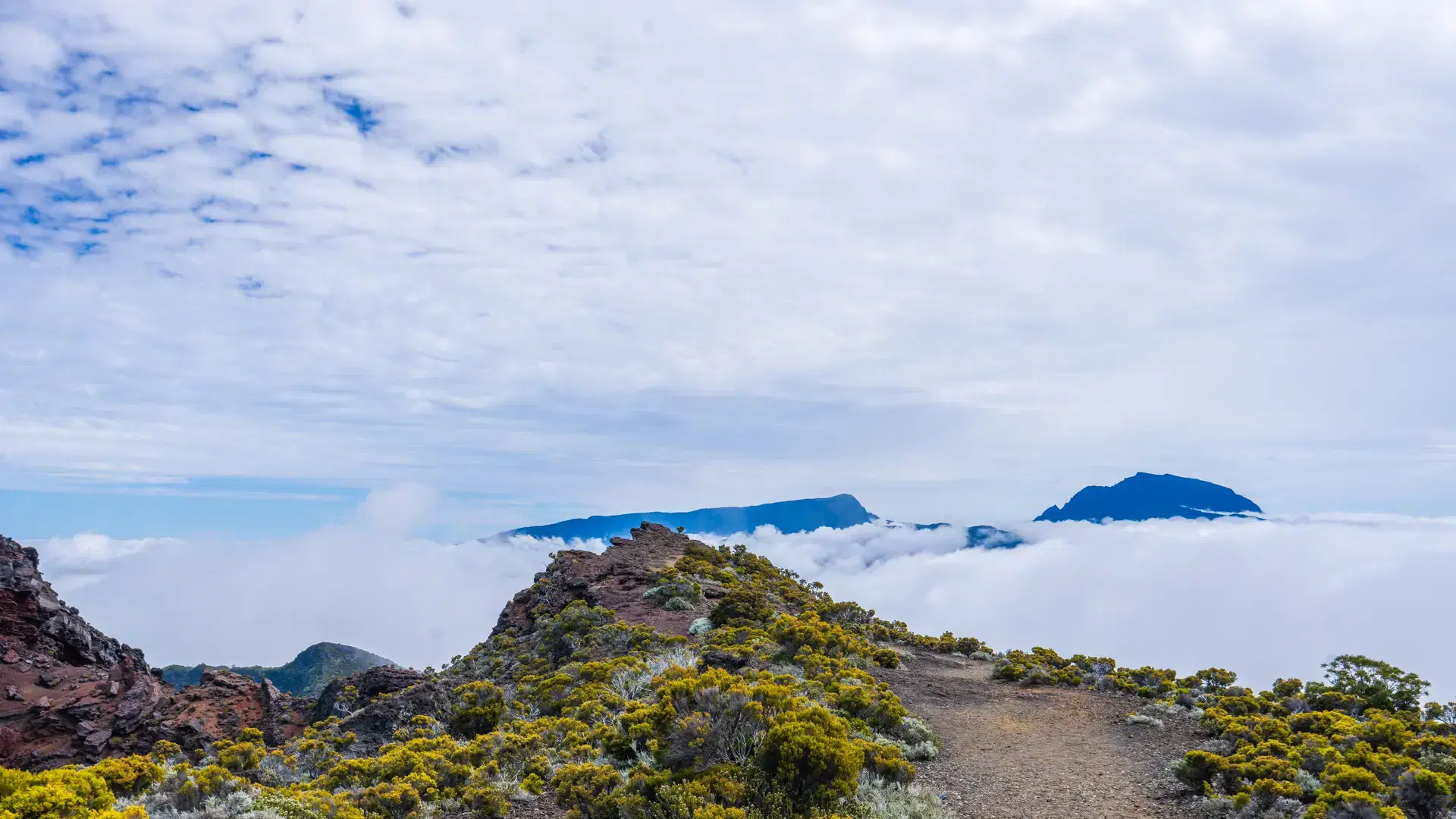 Stunning aerial view of Piton de la Fournaise, one of the most active volcanoes in the world. The volcano offers rugged terrain and stunning views of volcanic ash. Reunion Island, France.