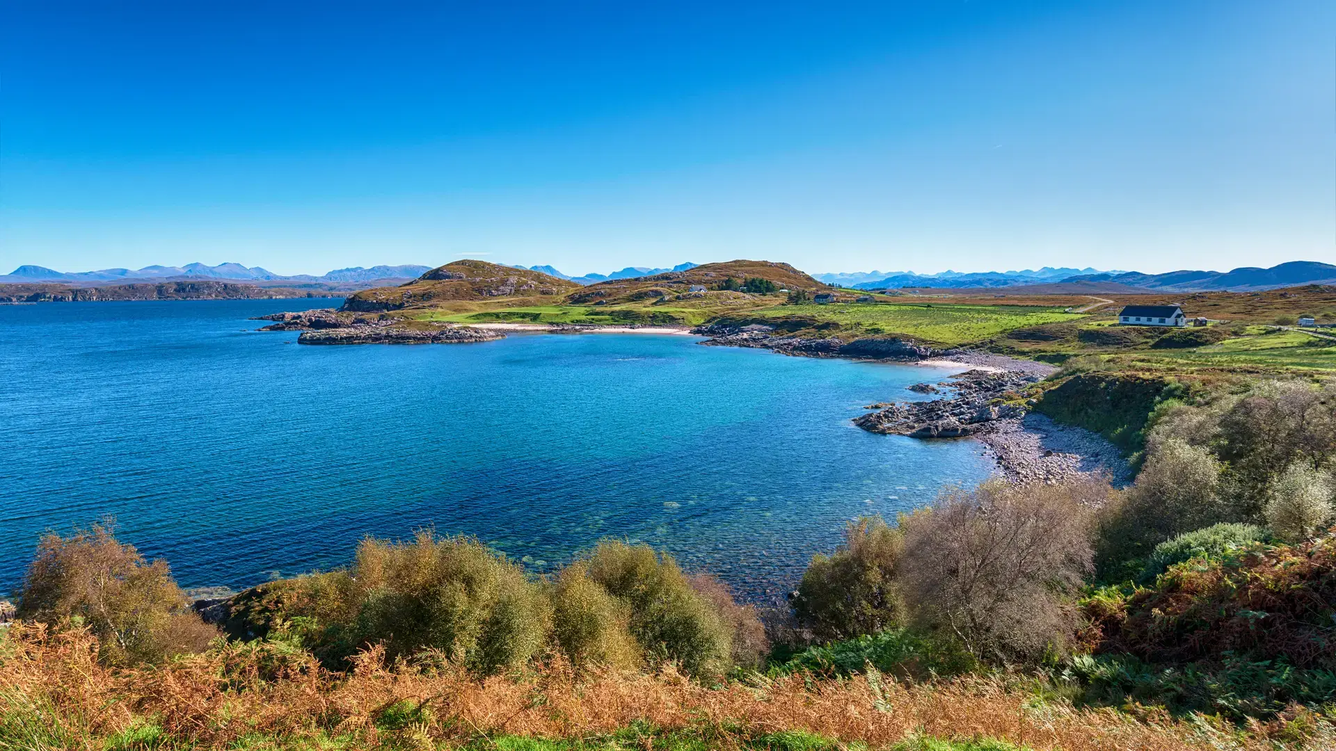 Blue skies over Inverasdale in Wester Ross in the Highlands of Scotland