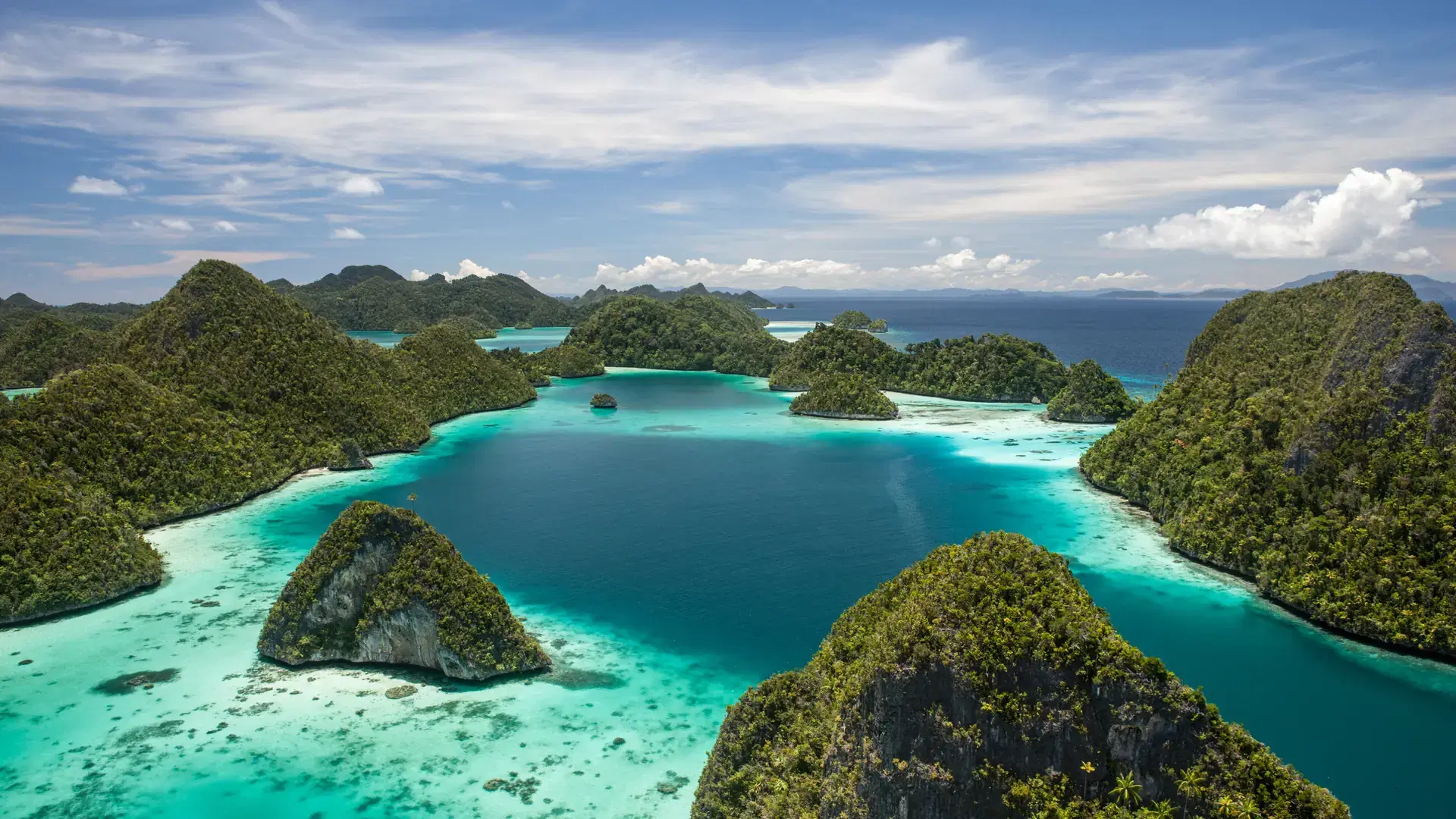 Limestone islands rise from a gorgeous lagoon in Wayag, Raja Ampat, Indonesia. This remote, tropical region is known as the heart of the Coral Triangle due to its incredible marine biodiversity.