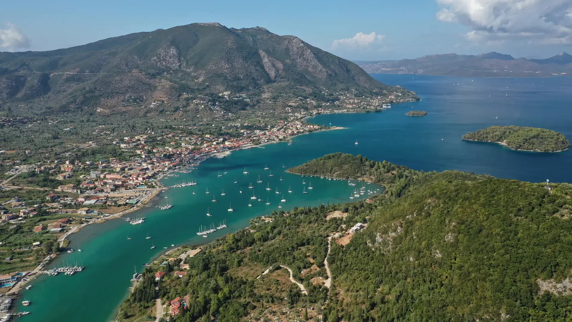 Aerial drone photo of fjord shaped port of Nydri a calm sea safe anchorage for sail boats and yachts famous for trips to Meganisi, Skorpios and other Ionian islands, Lefkada island, Greece