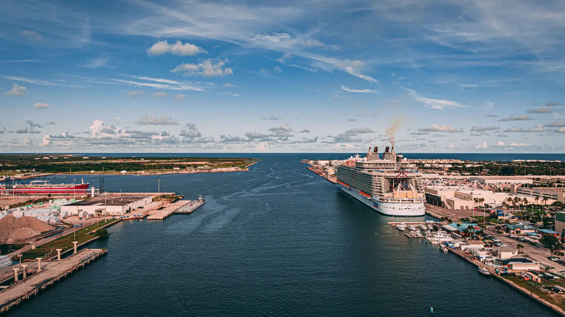 A drone shot of the blue sea and a big ship docked in the port of Cape Canaveral, Florida