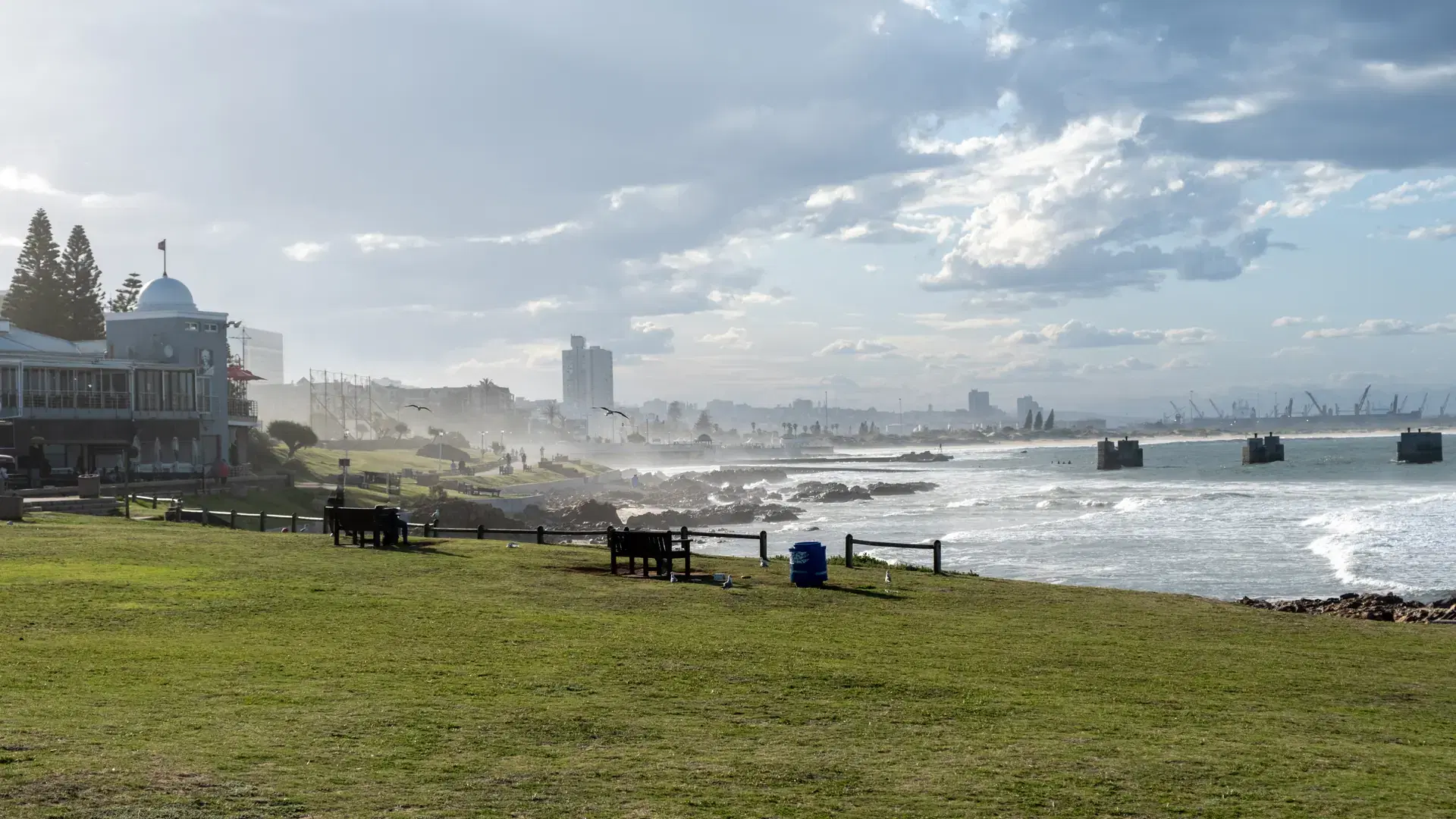 Port Elizabeth or Gqeberha, South Africa. Cityscape view from shark rock pier, ocean waves and cloudy blue sky