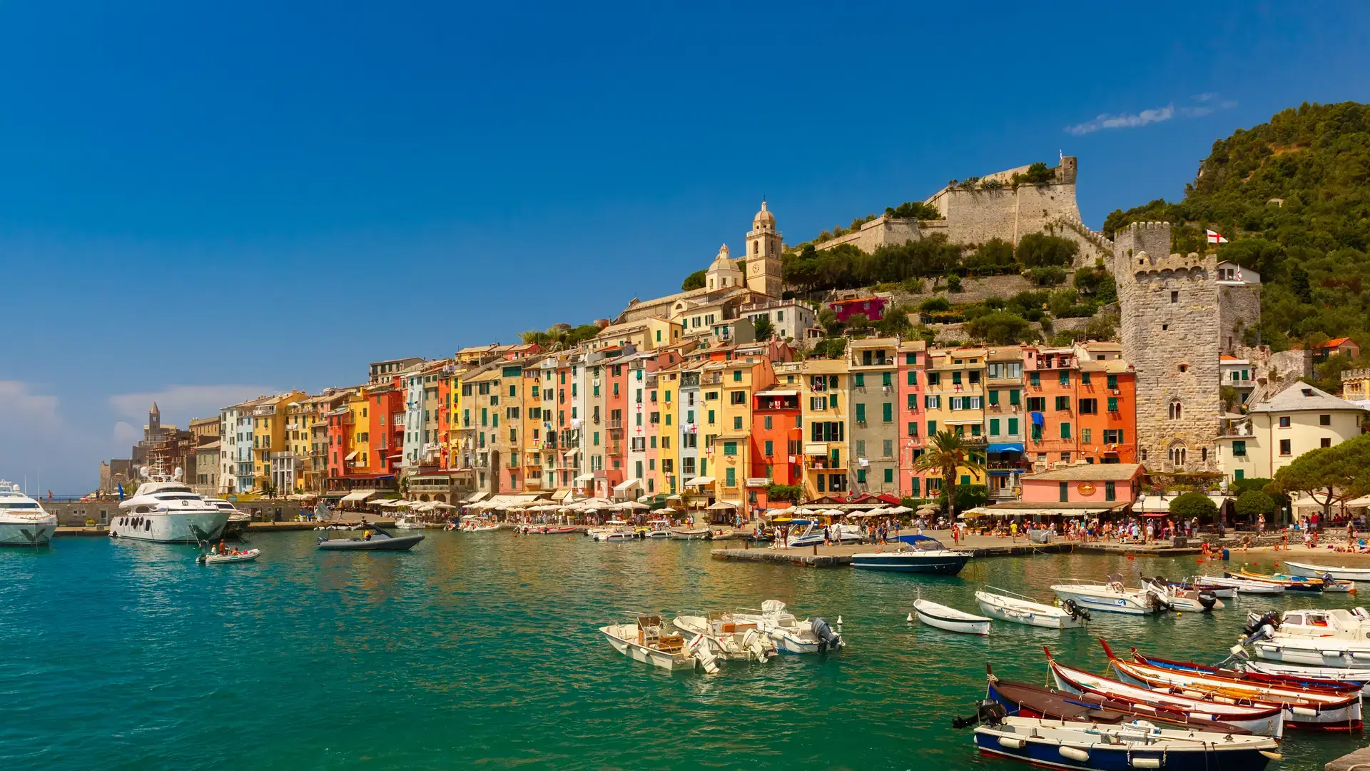Colorful picturesque harbour of Porto Venere with San Lorenzo church, Doria Castle and Gothic Church of St. Peter, Italian Riviera, Liguria, Italy.