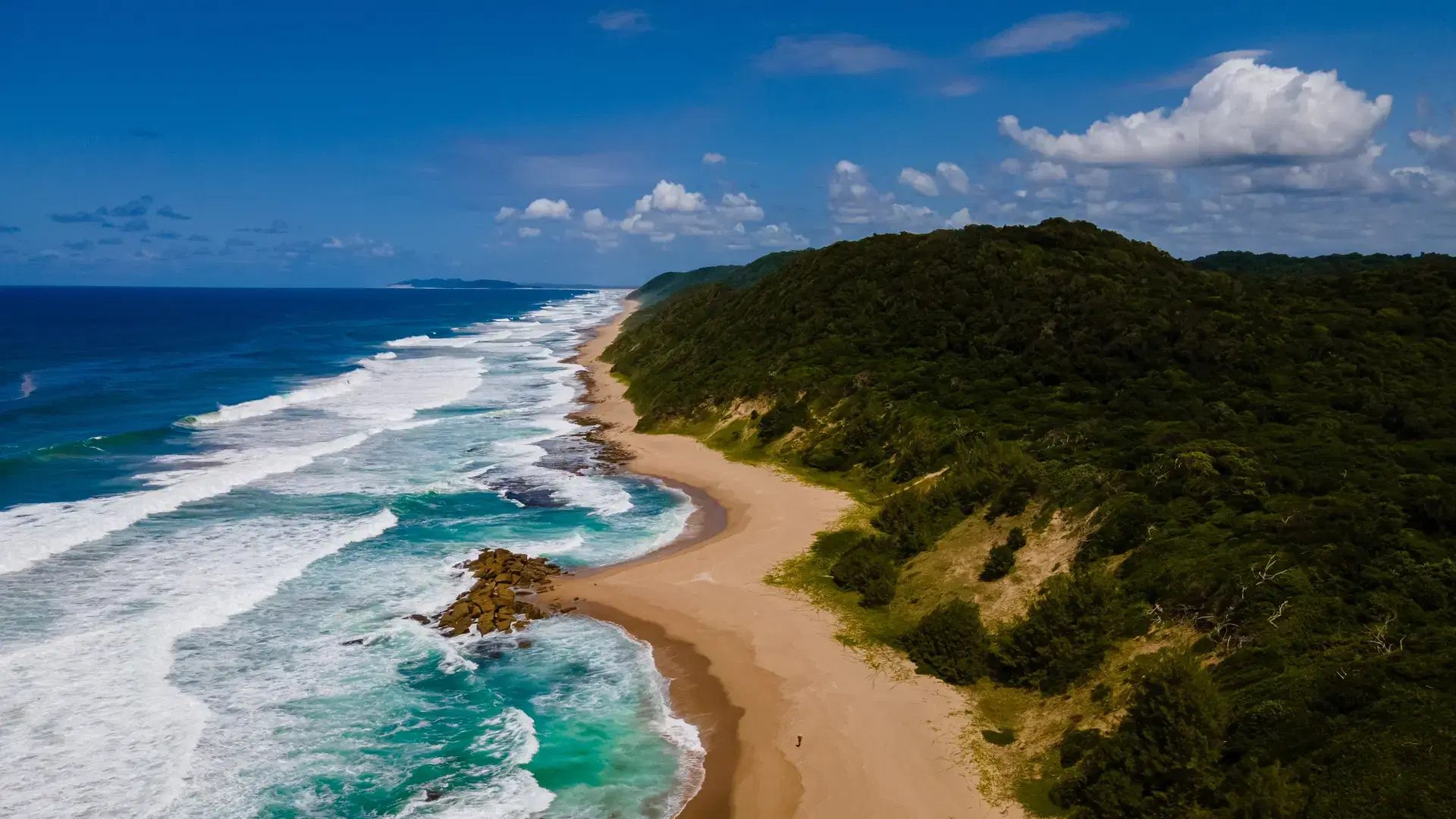 St Lucia South Africa, Rocks sand ocean, and blue coastal skyline at Mission Rocks beach near Cape Vidal in Isimangaliso Wetland Park in Zululand. South Africa St Lucia