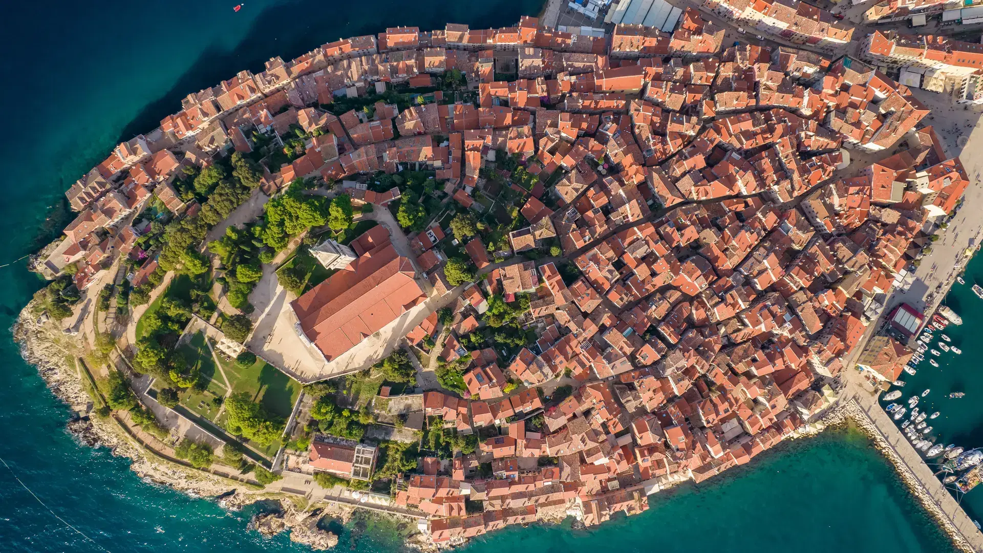 Aerial view of the Rovinj old town, famous ancient Croatian city at the Adriatic sea, Istria peninsula, Croatia. Rovinj cityscape, cathedral of St. Euphemia and historic buildings at sunset
