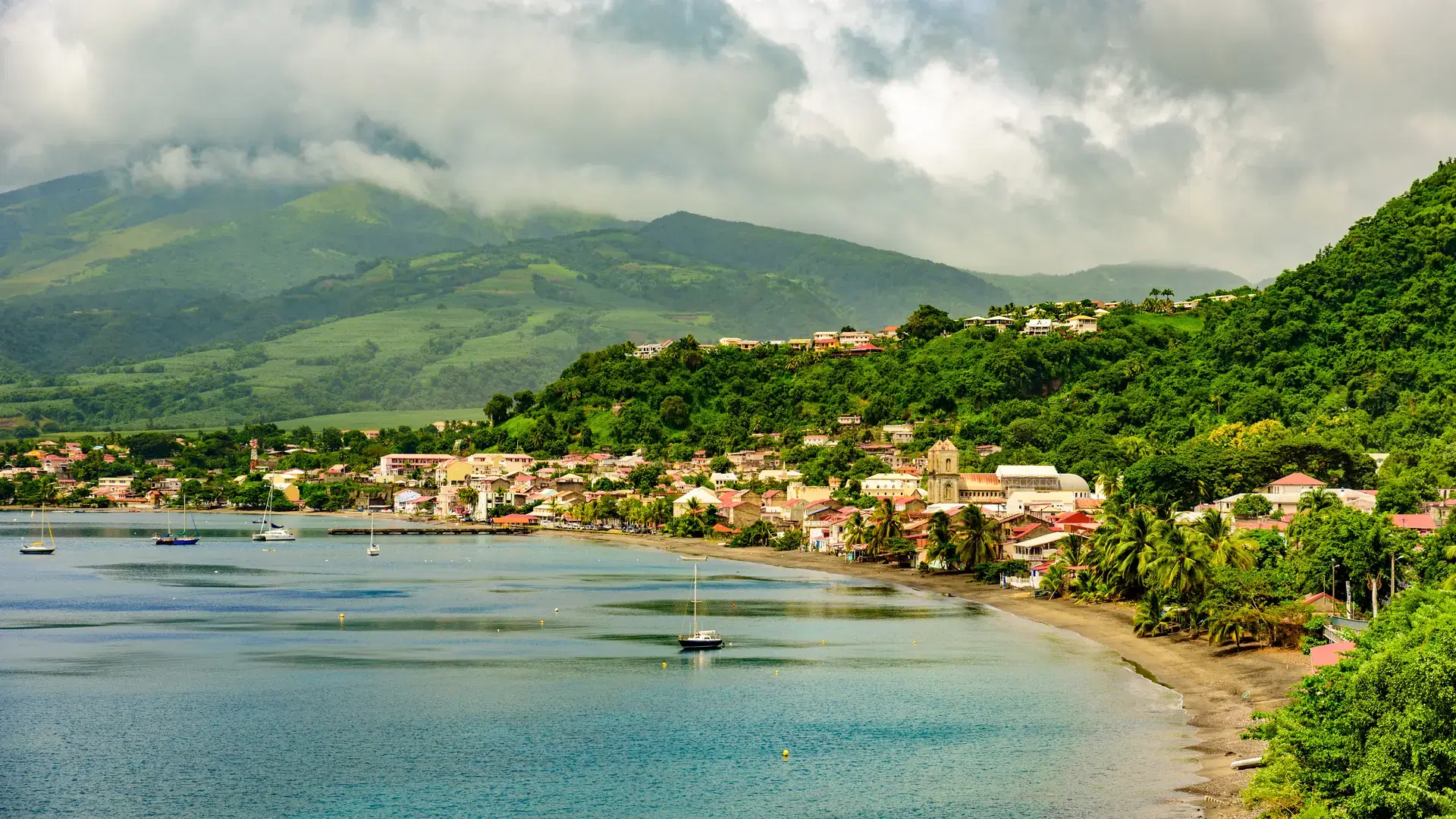 Paradise coast at Saint Pierre with Mt. Pelee, active volcanic mountain in Martinique, Caribbean Sea