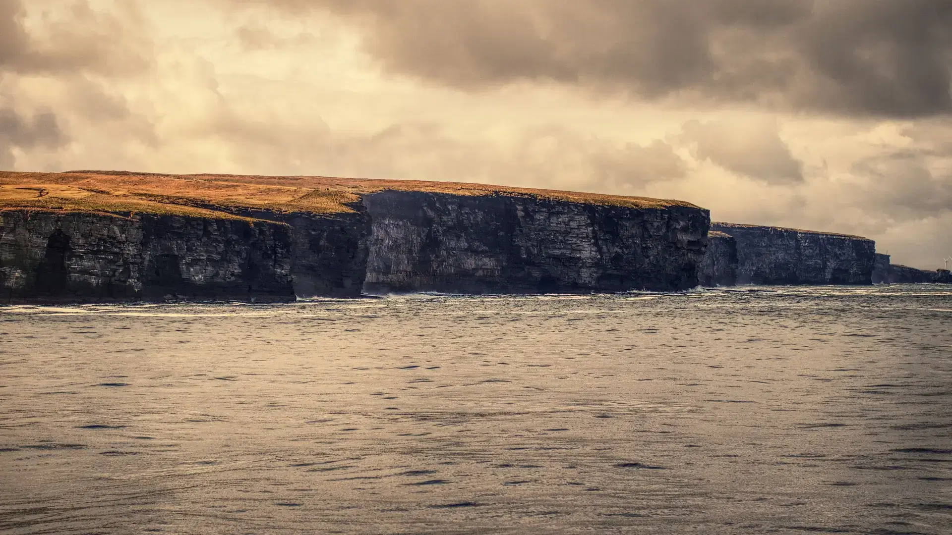A beautiful view of big cliffs at the North Coast on a cloudy day in Scrabster, Scotland