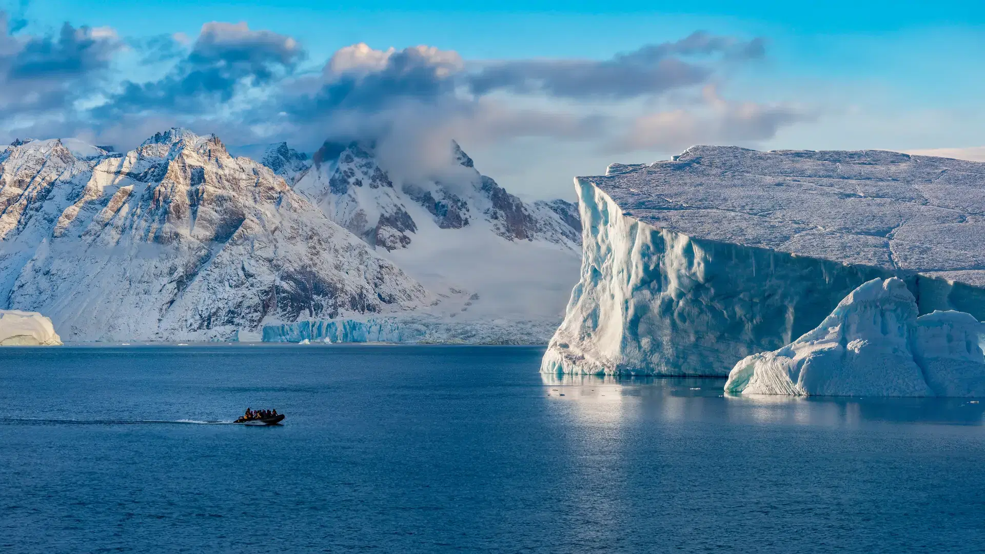 Adventure tourists in Scoresbysund in eastern Greenland in the late afternoon sunlight.