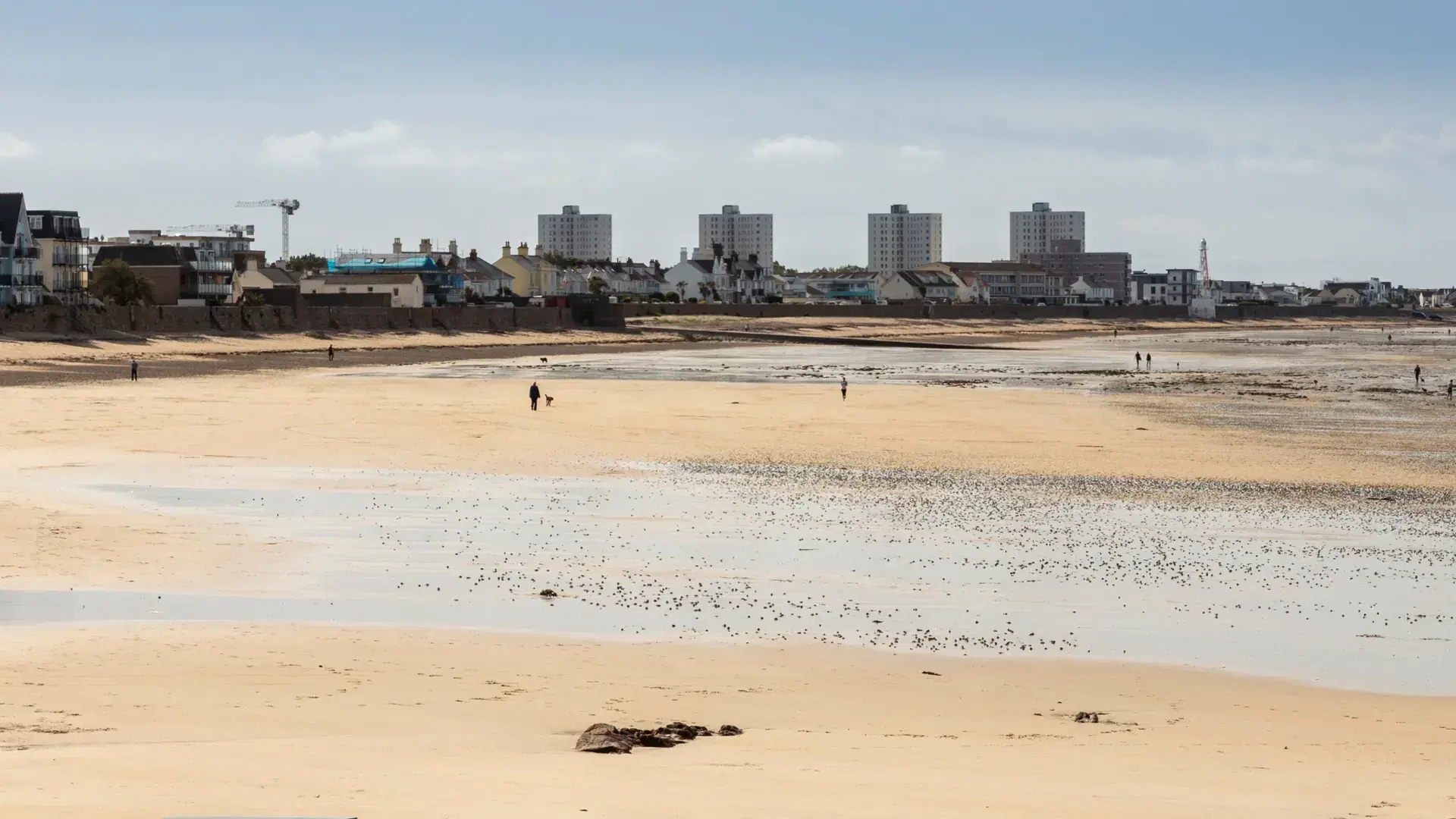 JERSEY, CHANNEL ISLANDS - JUNE 09, 2019: Panorama of the beach along Havre De Pas in St Helier with the tide out