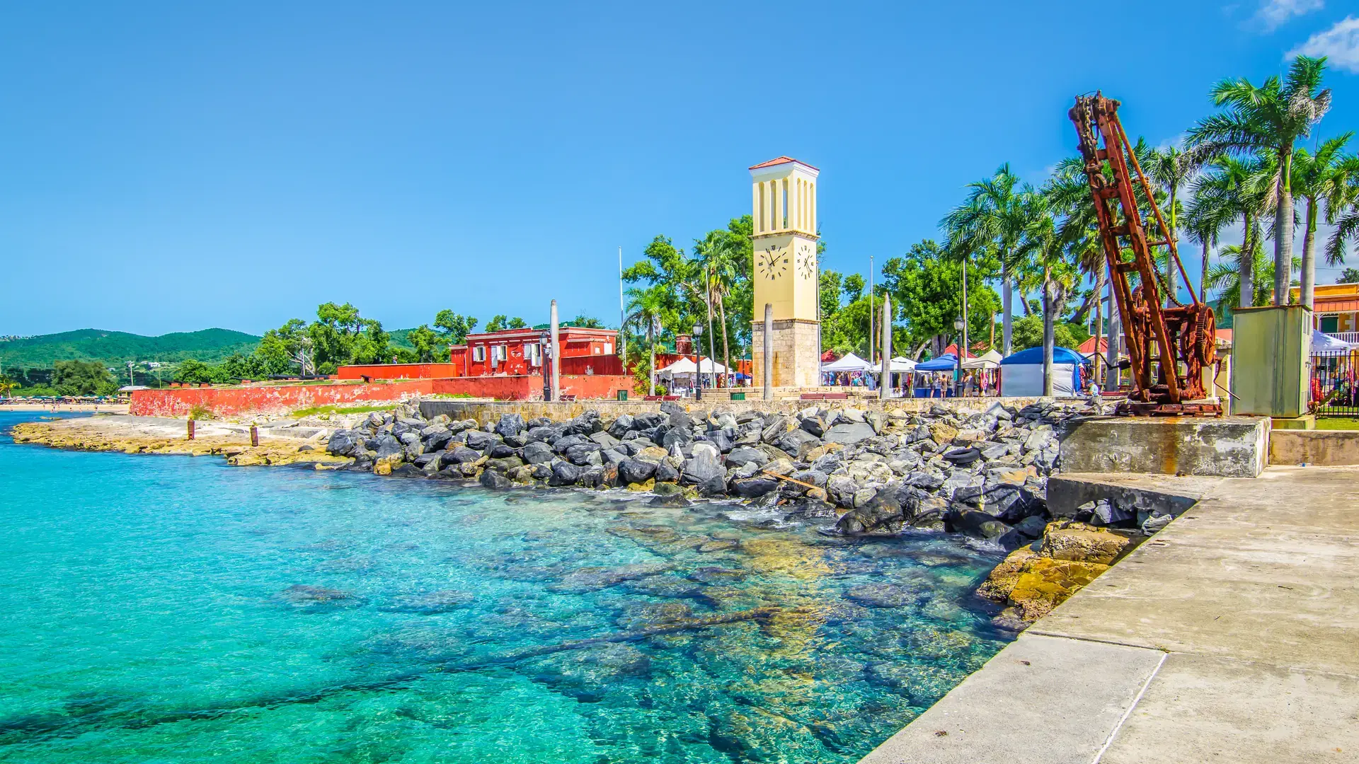 St Croix, Virgin Islands, Caribbean. Frederiksted cruise port with old Fort Frederik and clock tower at the waterfront.