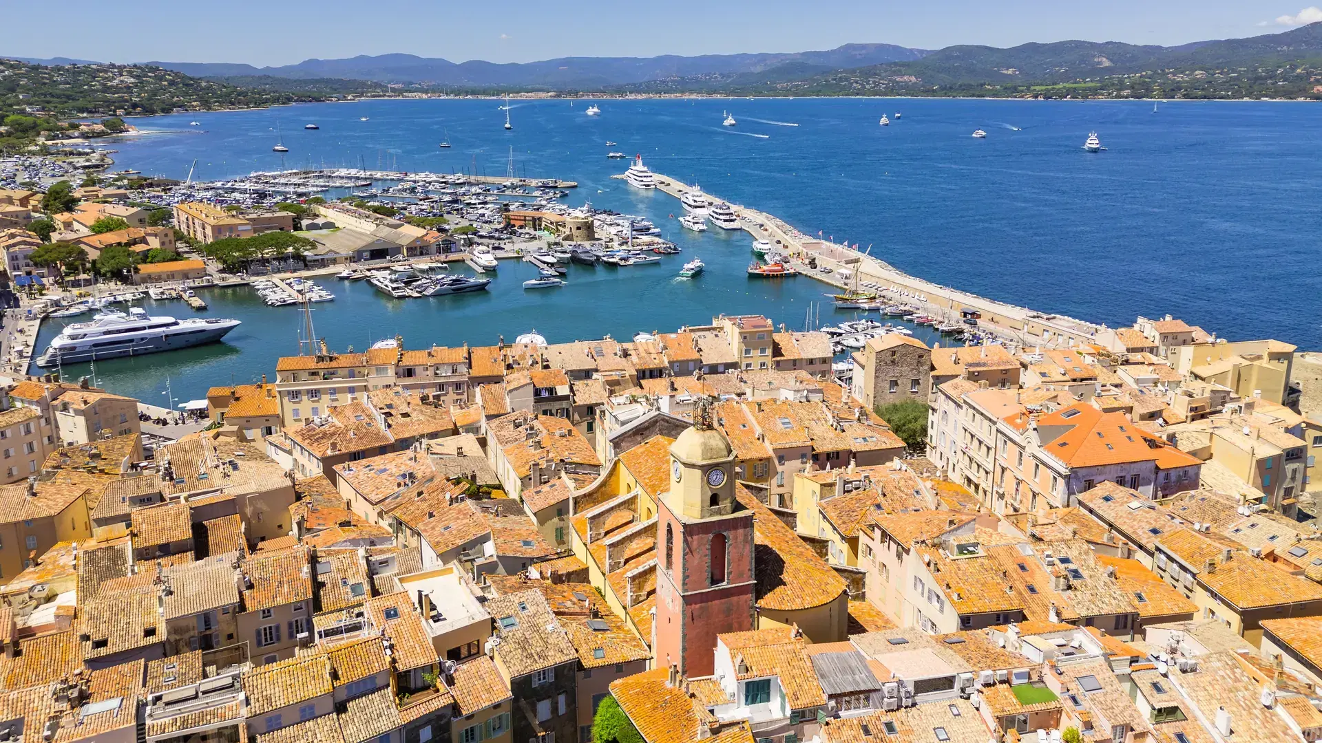 Saint-Tropez famous city on French Riviera Mediterranean Sea. Saint-Tropez colourful houses, church tower on the French Riviera