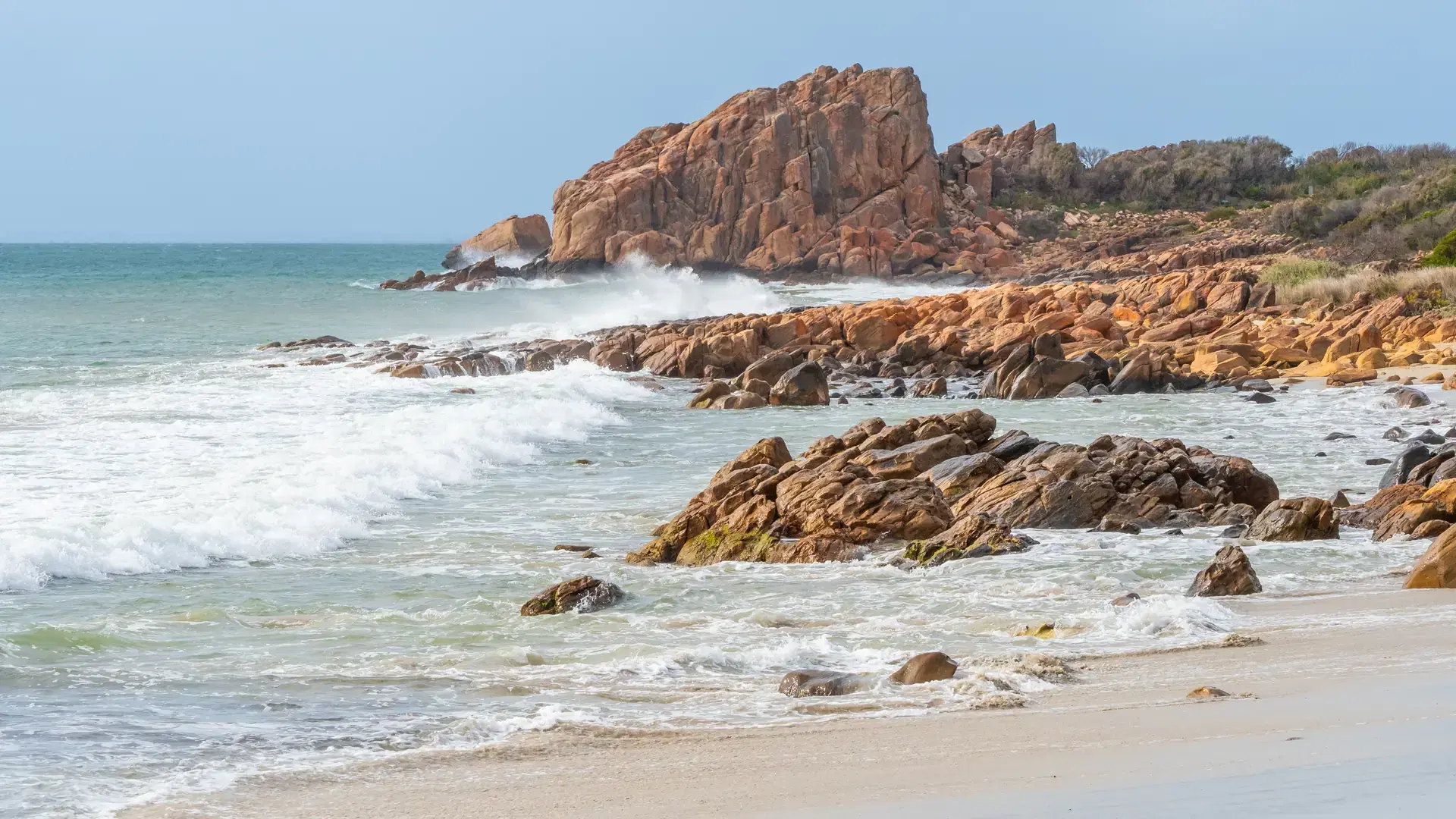 Castle Rock, near Dunsborough in Western Australia, is a massive chunk of orange granite standing tall at the end of beautiful Castle Bay.