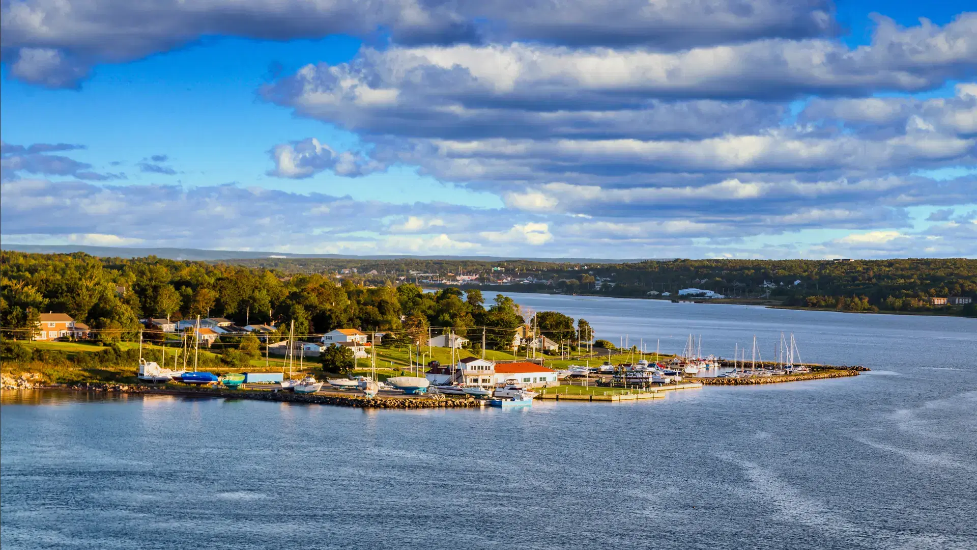 Homes and boats along the shore of Sydney, Nova Scotia, Canada
