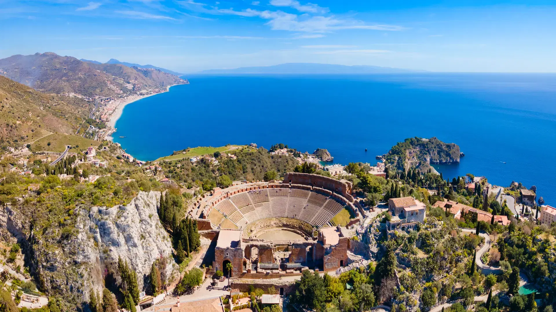The Ancient Theatre of Taormina or Teatro antico di Taormina aerial panoramic view, it is an ancient Greek theatre in Taormina city, Sicily island, Italy