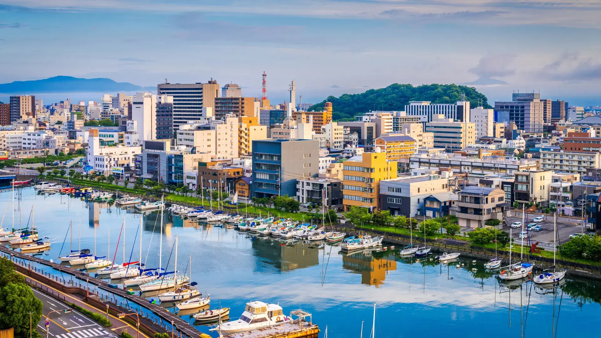 Tokushima, Japan cityscape over the Shinmachi River at dawn.