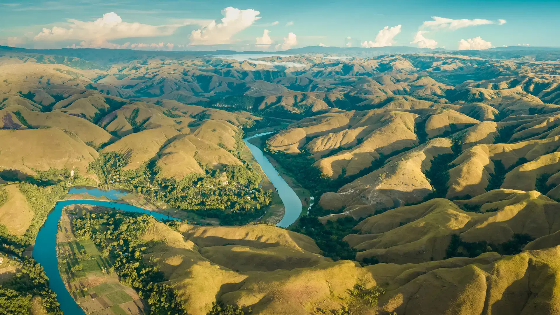 Mountain green hills panorama with curvy river, Merdeka Hill, Bukit Wairinding, East Sumba, Indonesia. Travel Background. Nature landscape. Untouched wild island. Vintage yellow toning